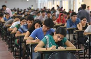 Exam hall with students seated in rows and writing IAS exam